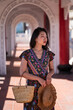 © Juan Alberto Ruiz/ADDICTIVE STOCK - Delighted Asian female traveler standing in arched passage of Cikang Overpass bridge and looking away while enjoying sightseeing during summer vacation in Taiwan
