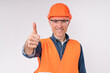 Confident caucasian male engineer in hardhat and uniform showing thumb up isolated over white background