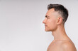 © InsideCreativeHouse - Side view shot of an attractive mature naked man isolated over white background