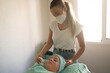 © Marina Gallardo/ADDICTIVE STOCK - High angle of female cosmetician doing laser epilation on forehead of young client lying on couch during beauty procedure in salon