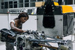 © Oscar Gimbal/ADDICTIVE STOCK - Serious young African American female mechanic assembling custom vehicle in modern repair service center