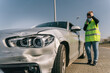 © Older Garcia/ADDICTIVE STOCK - Unhappy young female driver in yellow road safety vest and medical mask having phone conversation and checking damages on modern car parked on pavement after crash