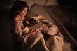 © Philippe Degroote/ADDICTIVE STOCK - From above of tranquil female reading notes in diary while sitting on floor under blanket with fluffy dog and enjoying evening in cozy house
