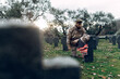 © Sergio Victor Vega/ADDICTIVE STOCK - Full body sorrowful soldier in camouflage outfit kneeling down in front of grave in military cemetery on early autumn day