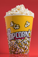 Bowl Full Of Popcorn On A Red Background