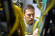 © The Trio Studio/ADDICTIVE STOCK - Concentrated male specialists working with wires in server while managing network in data center