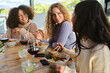 © Philippe Degroote/ADDICTIVE STOCK - Group of cheerful multiracial young women having fun while eating traditional Asian ramen during dinner in restaurant