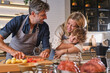 © Philippe Degroote/ADDICTIVE STOCK - Cheerful parents and son smiling and hugging each other while peeling fresh tomato during lunch preparation in kitchen at home