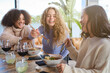 © Philippe Degroote/ADDICTIVE STOCK - Group of cheerful multiracial young women having fun while eating traditional Asian ramen during dinner in restaurant