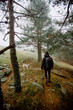 © Ruben Soto/ADDICTIVE STOCK - Back view of anonymous male walking along path in woods with dog on foggy day
