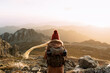 © Sergio Victor Vega/ADDICTIVE STOCK - Back view of unrecognizable hiker standing on stone and observing amazing scenery of highlands valley on sunny day
