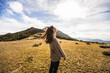 © Ruben Soto/ADDICTIVE STOCK - Side view of young gentle female traveler in casual outfit with eyes closed against mount in sunlight in Spain