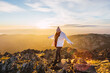 © Ruben Soto/ADDICTIVE STOCK - Anonymous female tourist in outerwear strolling on rough stones in mountains under cloudy sky at shiny dawn in back lit