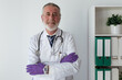 © Sergio Victor Vega/ADDICTIVE STOCK - Physician in robe with stethoscope putting on sterile gloves in clinic in daytime