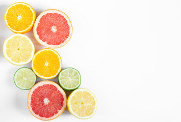 citrus fruits orange, grapefruit, lemon and lime on white horizontal background