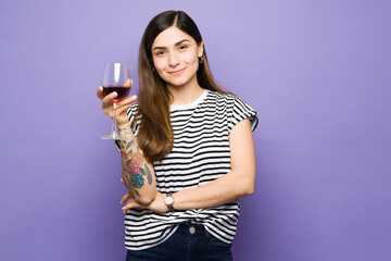 Beautiful young woman drinking a glass of red wine