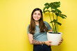 © AntonioDiaz - Portrait of a happy woman taking care of her houseplant