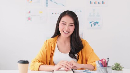 Wall Mural - Young Asian business woman attending remote video call conference meeting, look at camera, in home office. Internet technology social distancing or work at home lifestyle concept