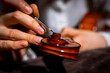 young Chinese violin maker at work in her workshop