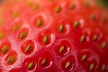 Macro of a red fresh strawberry with yellow seeds 