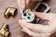 © Andrii - old clogged broken faucet cartridge. handyman repair leaky faucet. water tap fix service concept