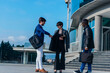 © qunica.com - Business partners greeting one another by shaking hands outside workplace