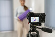 © Miljan Živković - Front view on young caucasian woman at home recording and streaming online video on camera for online training - Girl using foam roller for workout in room - health and fitness concept