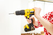 © Voyagerix - Hand holding yellow drill
