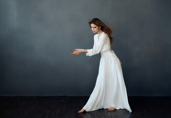 Woman in white dress dance performance luxury glamor gray background