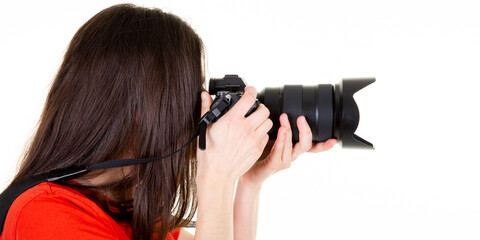 Wall Mural - profile brown hair woman photographer taking a photo isolated on white background in side view