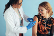 Woman getting flu shot in clinic