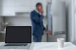 © zinkevych - Elegant dark-skinned man standing near the fridge and talking on the phone