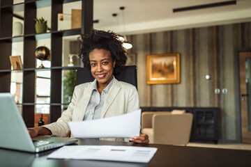 Wall Mural - Posing for camera, while sitting at her office.