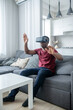 © zinkevych - A dark-skinned young man sitting in VR glasses