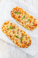 Wall Mural - Tarte Flambee - flat bread (Flammkuchen) with bacon, onion, champignon and cheese