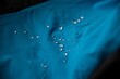 Hydrophobic effect on blue waterproof fabric on mountain trousers