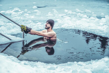 Winter Swimming. Man In An Ice-hole.