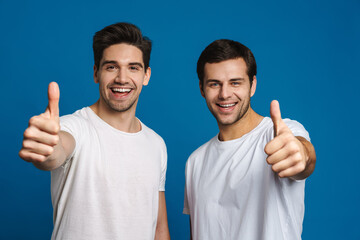 Joyful handsome guys smiling and showing thumbs up