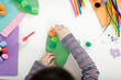 © M-image - young girl hand makes caterpillar craft for home schooling