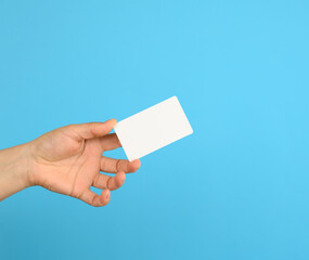 female hand holding a white black business card
