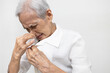 Elderly was sniffing her clothes smell musty or shirt smell moldy,bad smell,foul odor from washing,unclean laundry,senior woman is smelling stinky,scent detergent,pungent fragrance of fabric softener