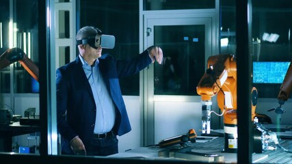 Wall Mural - male researcher is operating a robotic mechanism in a virtual reality