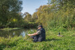 © alexey351 - Young man with a mug sits in nature.