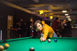© liderina - Woman playing billiard alone.