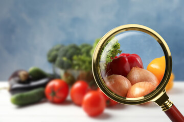 Wall Mural - view through magnifying glass on vegetables, closeup. poison detection