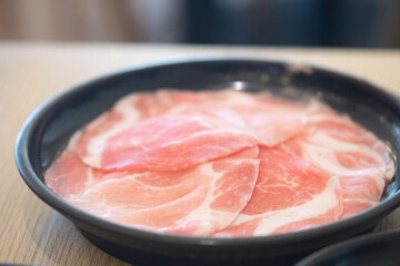 Wall Mural - Fresh pork thinly sliced on black dish