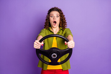 Sticker - Photo of young crazy amazed surprised woman hold steering wheel riding fast speed isolated on purple color background