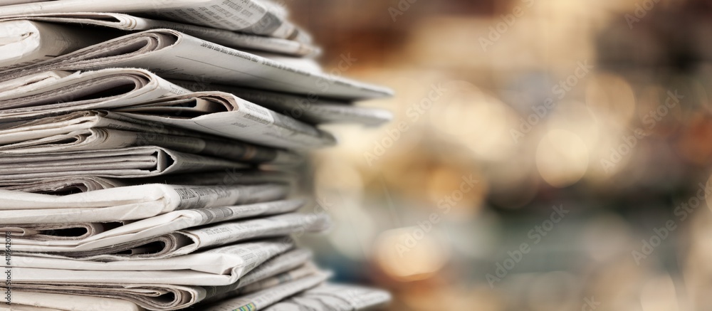 Pile of newspapers stacks on blur background - obrazy, fototapety, plakaty 