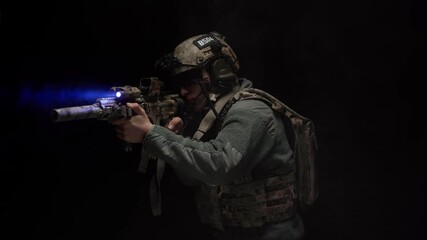 Wall Mural - US Special forces soldier aiming with rifle at night in darkness