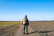 © serejkakovalev - Male traveler with tactical and militari equipment walk alone in sunny day